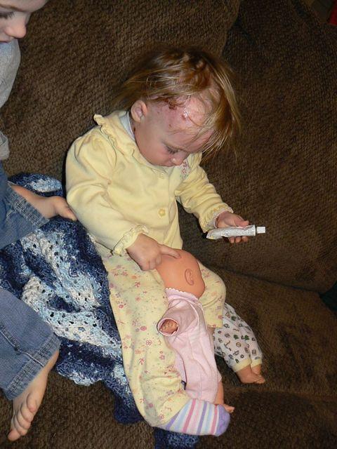 putting bacitracin on the baby dolls!